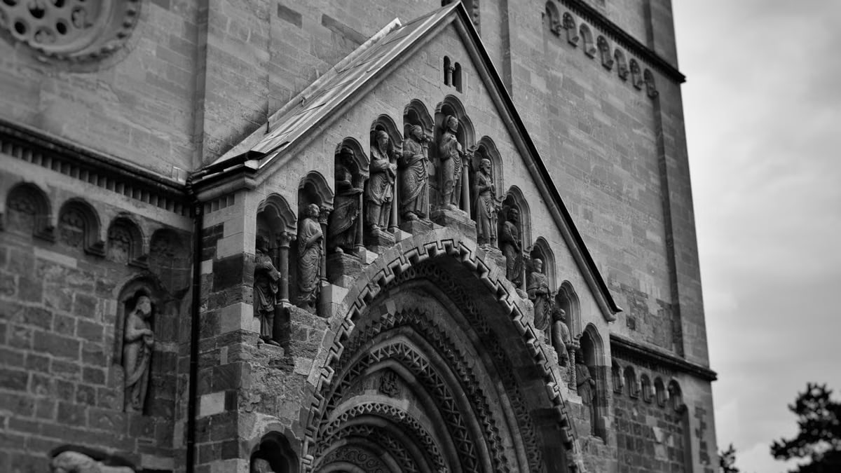 Vintage-style photograph capturing the intricate details of Ják Church's façade in Hungary.